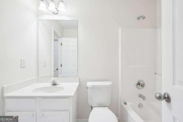 full bathroom featuring vanity, washtub / shower combination, and toilet