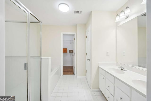 bathroom featuring vanity, tile patterned floors, and shower with separate bathtub