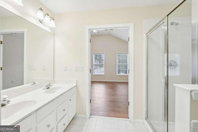 bathroom featuring vaulted ceiling, vanity, an enclosed shower, and tile patterned flooring