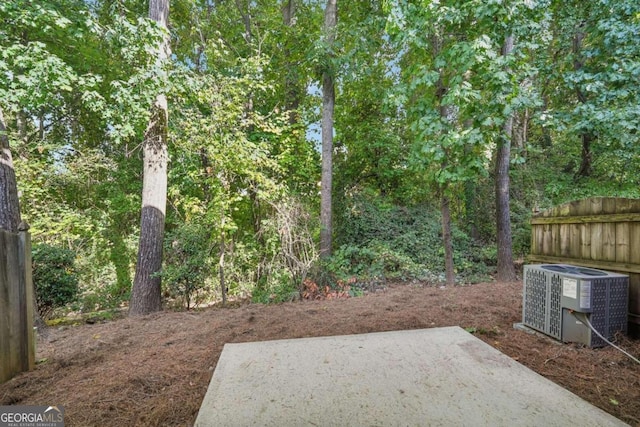 view of yard featuring a patio area and central air condition unit