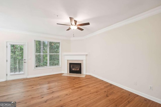 unfurnished living room featuring crown molding, ceiling fan, and light wood-type flooring