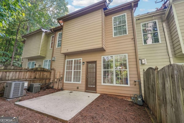 rear view of house featuring a patio area and central air condition unit