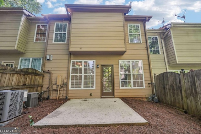 rear view of property featuring cooling unit and a patio area