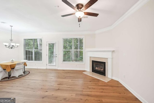 unfurnished living room with crown molding, a healthy amount of sunlight, and light hardwood / wood-style flooring