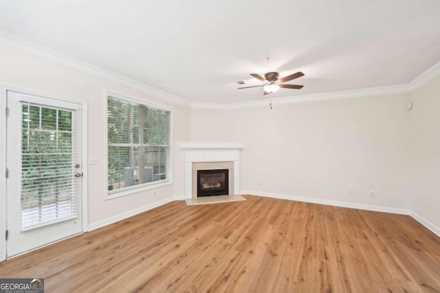 unfurnished living room featuring crown molding, ceiling fan, and light hardwood / wood-style floors