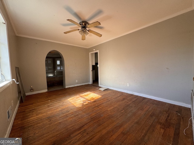 empty room with ornamental molding, dark hardwood / wood-style floors, and ceiling fan