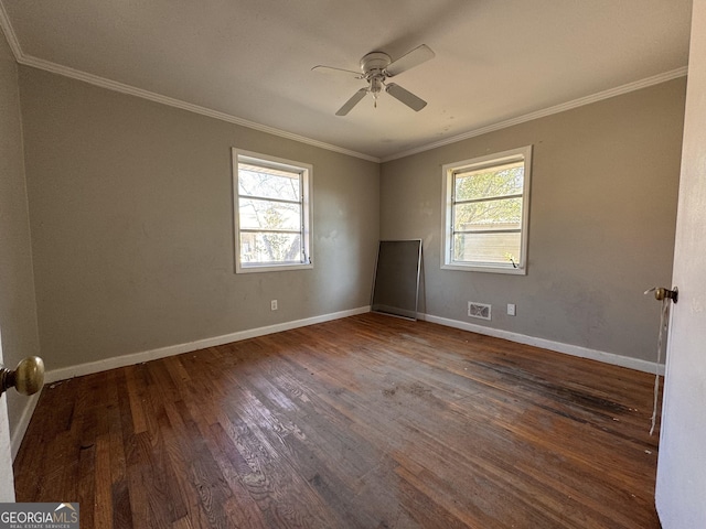 empty room featuring crown molding, ceiling fan, plenty of natural light, and dark hardwood / wood-style floors