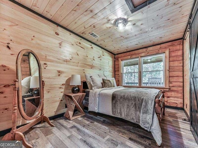 bedroom featuring wood walls, dark hardwood / wood-style floors, and wooden ceiling