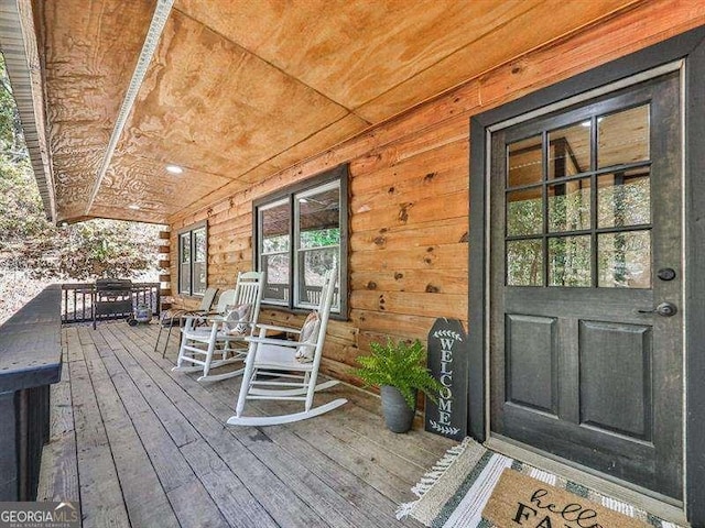 wooden terrace featuring covered porch