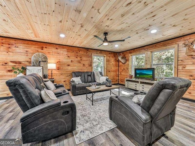 living room featuring ceiling fan, wood walls, wood ceiling, and light hardwood / wood-style flooring