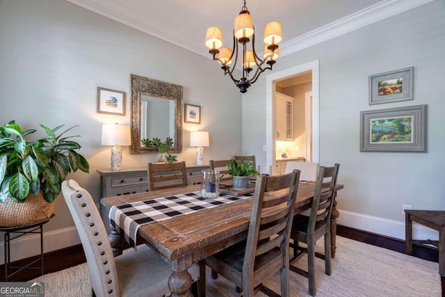 dining space with an inviting chandelier, ornamental molding, and dark hardwood / wood-style flooring