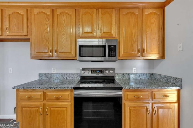 kitchen featuring appliances with stainless steel finishes and stone countertops