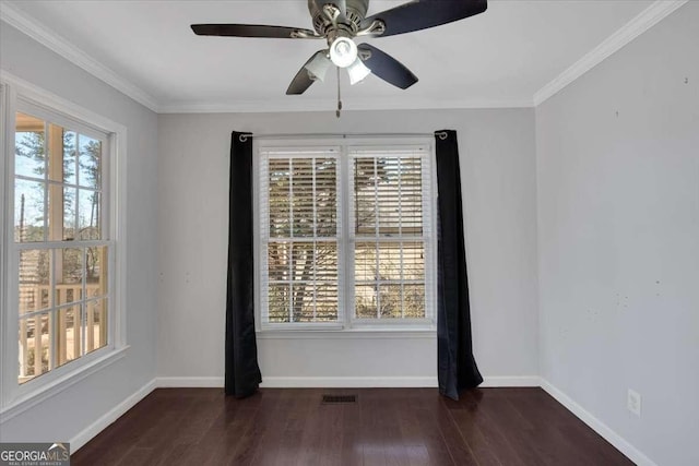 spare room featuring ceiling fan, ornamental molding, dark hardwood / wood-style floors, and a healthy amount of sunlight