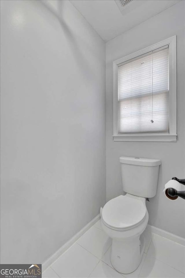 bathroom featuring tile patterned flooring and toilet