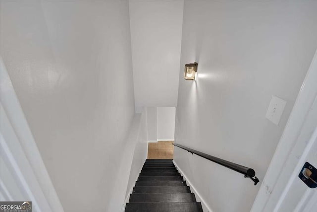 stairway featuring wood-type flooring