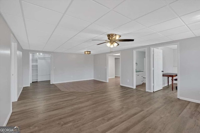 interior space with hardwood / wood-style floors, a paneled ceiling, and ceiling fan