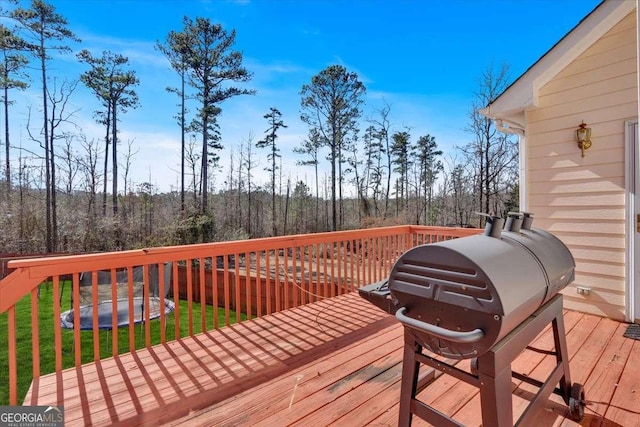 deck featuring grilling area and a yard