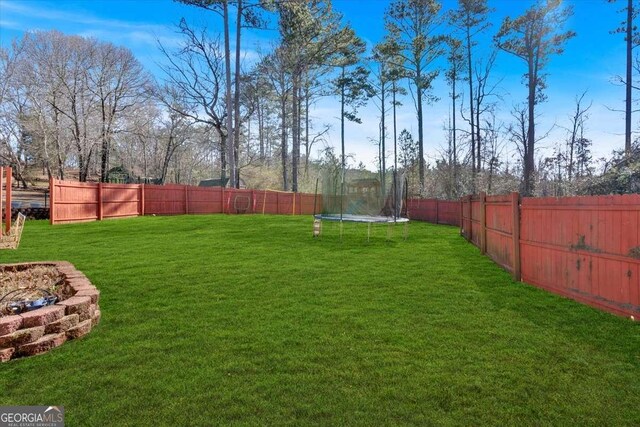 view of yard with a trampoline