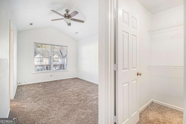 interior space with carpet, lofted ceiling, and ceiling fan