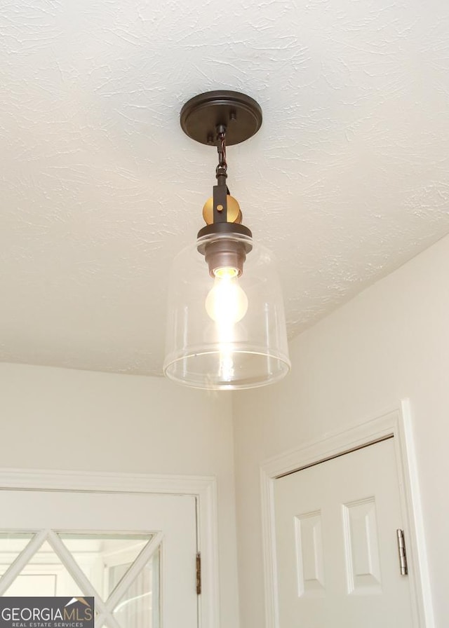 details with a textured ceiling