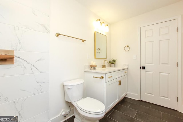 bathroom featuring vanity, toilet, and tile patterned flooring