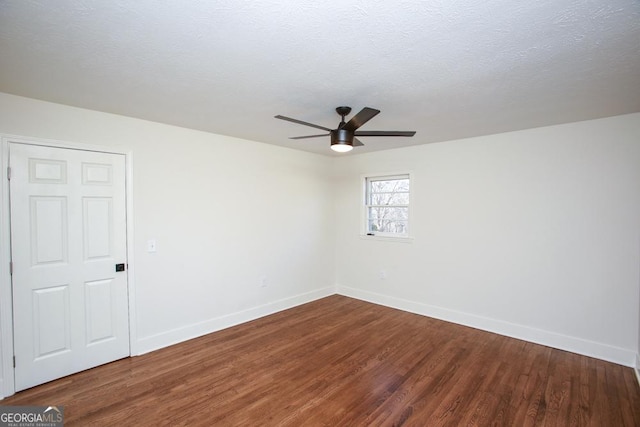 empty room with ceiling fan, hardwood / wood-style floors, and a textured ceiling