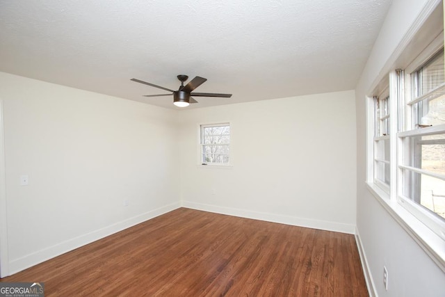 empty room featuring ceiling fan, hardwood / wood-style floors, and a textured ceiling