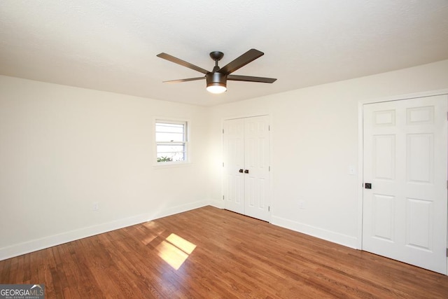 unfurnished room with hardwood / wood-style flooring and ceiling fan