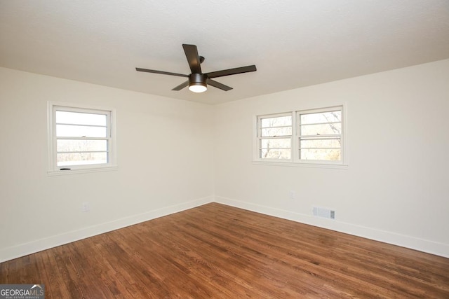 spare room with hardwood / wood-style flooring and ceiling fan