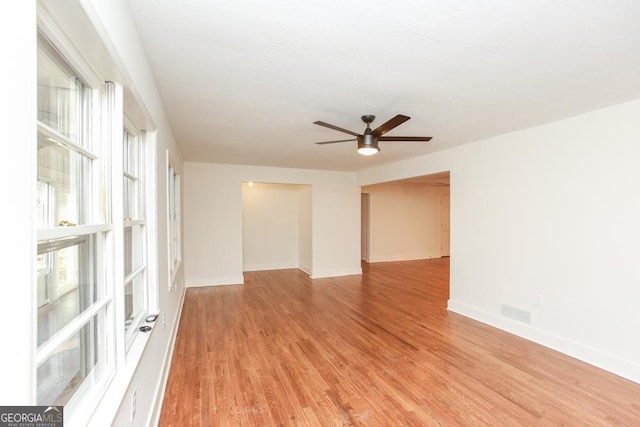 unfurnished room with ceiling fan and light wood-type flooring