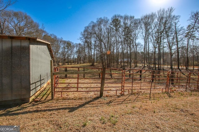 view of yard featuring a rural view and an outbuilding