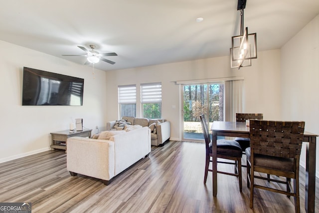 living room with wood-type flooring and ceiling fan