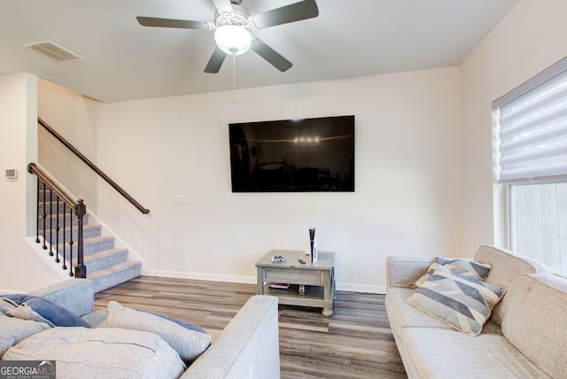 living room featuring hardwood / wood-style flooring and ceiling fan