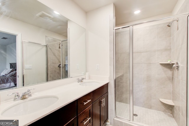 bathroom featuring vanity and an enclosed shower