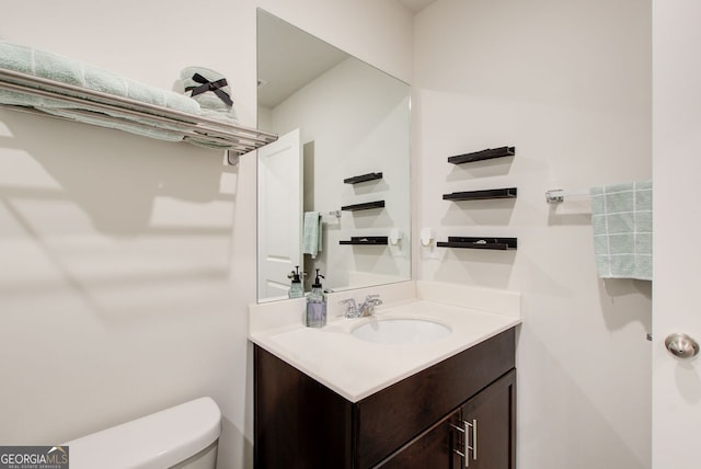 bathroom featuring vanity and toilet