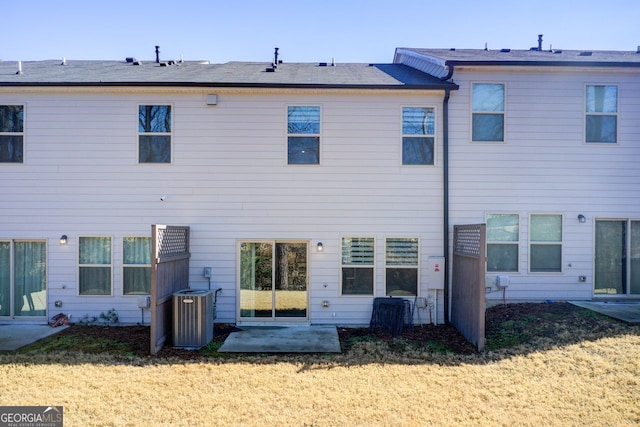 back of house with a yard, central AC unit, and a patio area