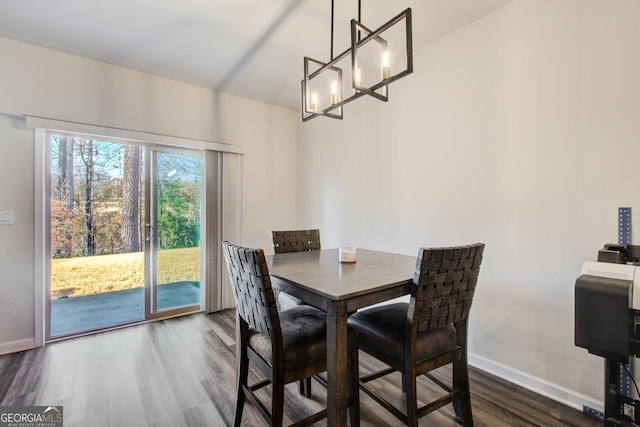 dining room featuring dark hardwood / wood-style floors and a notable chandelier