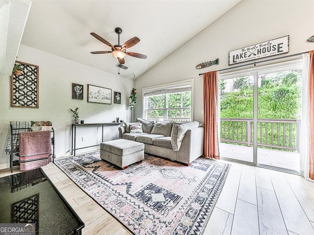 living room featuring hardwood / wood-style flooring, ceiling fan, and high vaulted ceiling