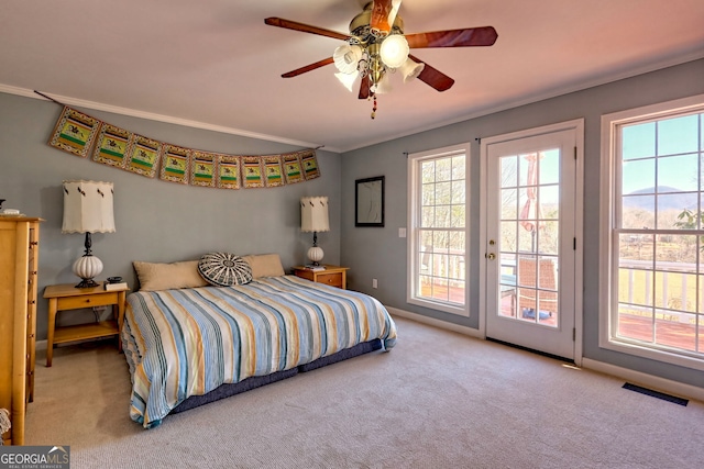 carpeted bedroom featuring ceiling fan, ornamental molding, and access to exterior