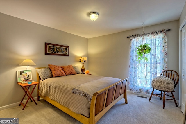 bedroom featuring light carpet