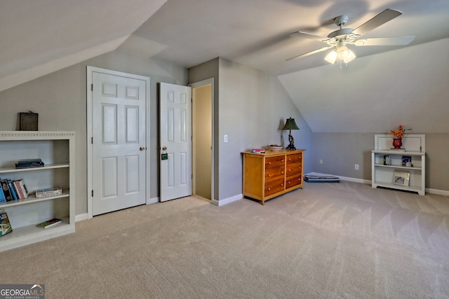 additional living space with light carpet, lofted ceiling, and ceiling fan