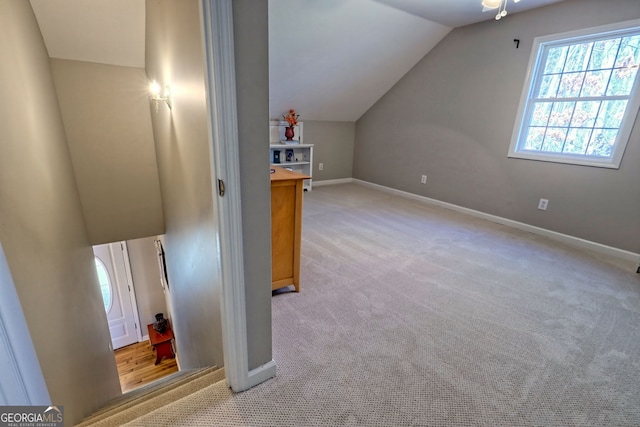 additional living space with light carpet and lofted ceiling