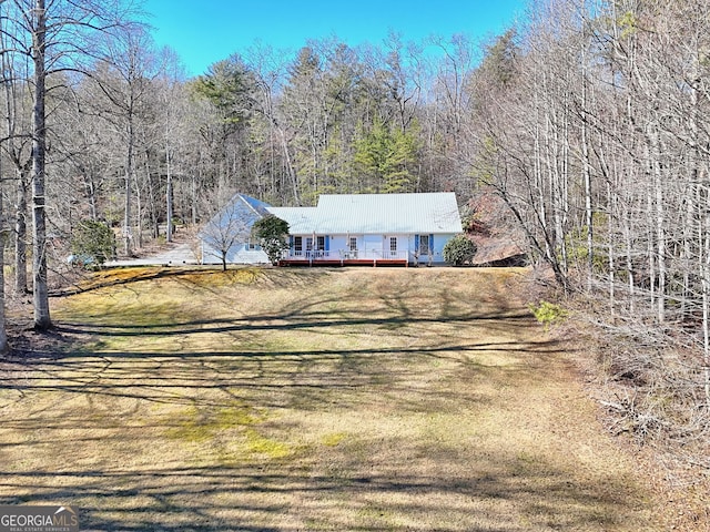 view of front of house featuring a front yard and a deck