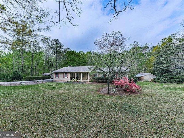 ranch-style home featuring a front yard and a porch