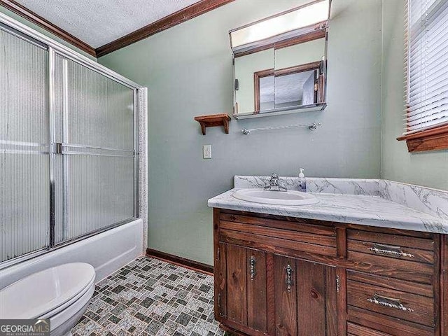 full bathroom featuring shower / bath combination with glass door, ornamental molding, vanity, toilet, and a textured ceiling