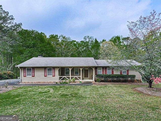 ranch-style home featuring a porch and a front lawn