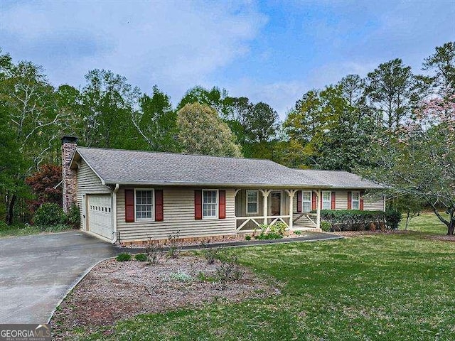 ranch-style house with a garage and a front yard