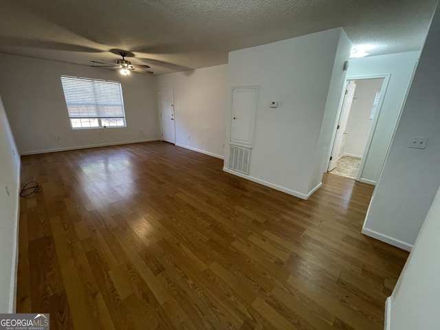 unfurnished room featuring hardwood / wood-style floors, a textured ceiling, and ceiling fan