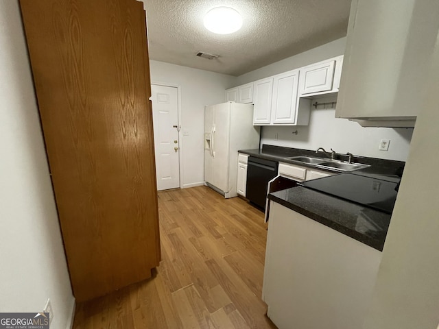 kitchen featuring dishwasher, sink, white cabinets, white refrigerator with ice dispenser, and light hardwood / wood-style flooring