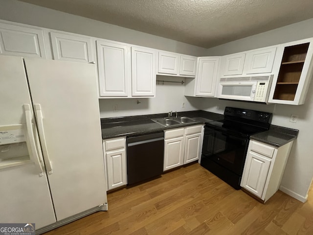 kitchen featuring sink, white cabinetry, wood-type flooring, a textured ceiling, and black appliances